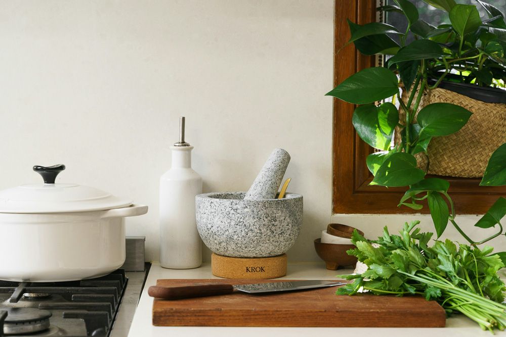 mortar and pestle kitchen decor surrounded by plants