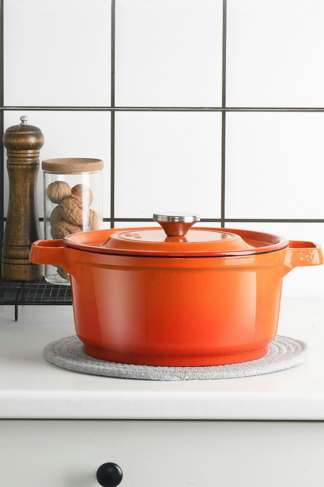 orange le creuset for kitchen decor sitting on a white kitchen counter