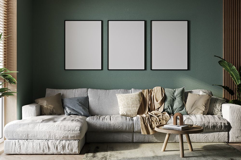 grey sofa and sage green wall in a living room