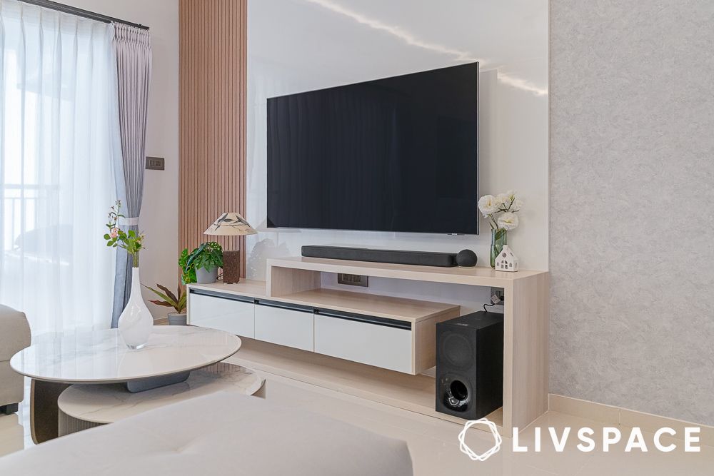 tv unit in 20 lakh budget house design with wooden fluted panels and white backdrop