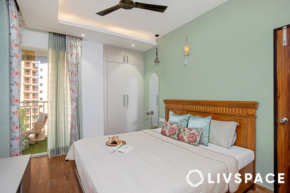 pastel green coloured bedroom in 20 lakhs house plan