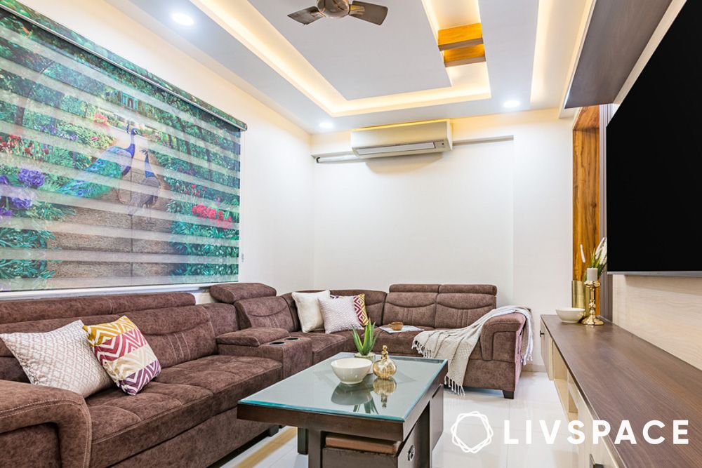 living room with false ceiling design and brown sofa in 20 lakh house design