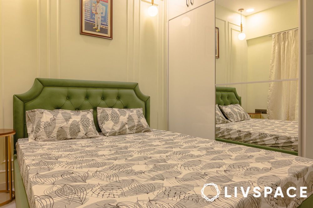 Bedroom design with green headboard design and mirrored wardrobe