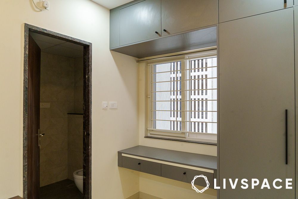 floating study table attached to brownish grey wardrobe