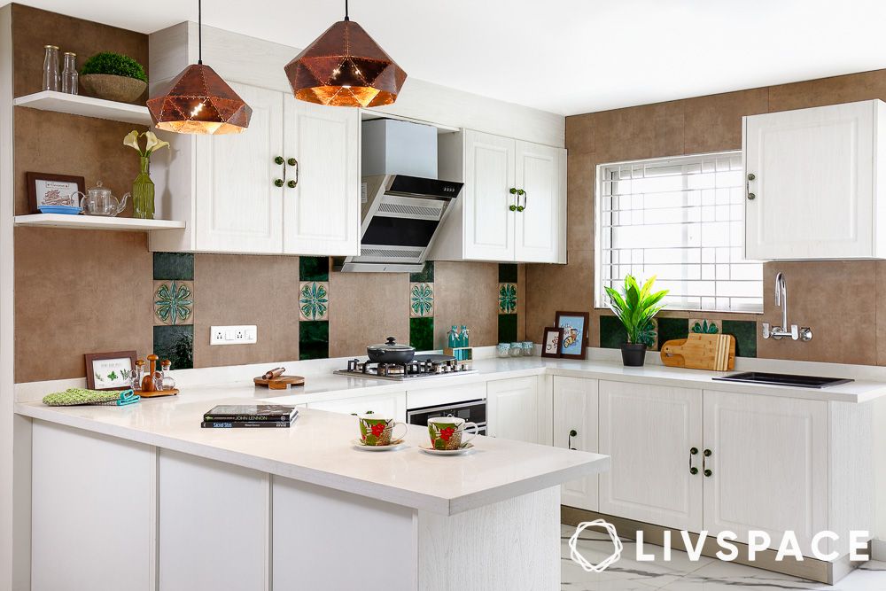 a white kitchen with unique backsplash