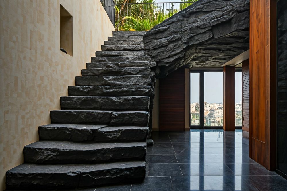 duplex house steps interior design with Black rock boulder