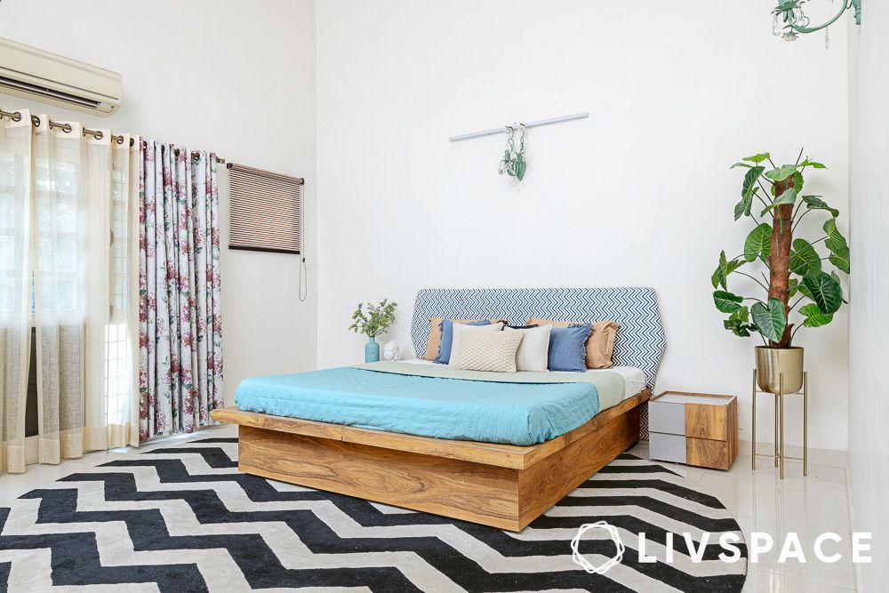 a patterned rug in a minimalist bedroom
