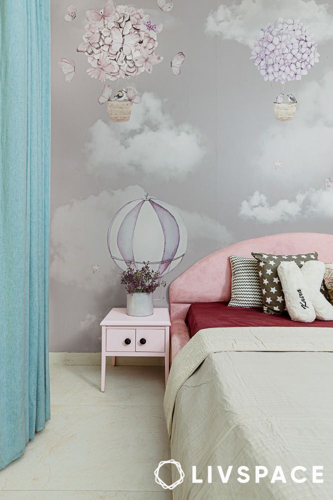 a cute pink bedside table next to the bed