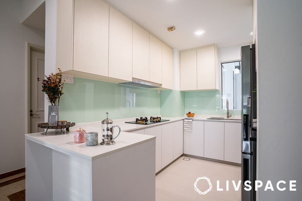 white kitchen design with mint green glass backsplash