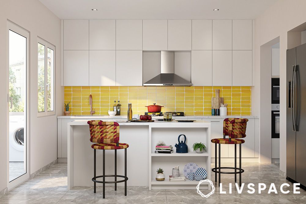 white cabinets island and yellow backsplash
