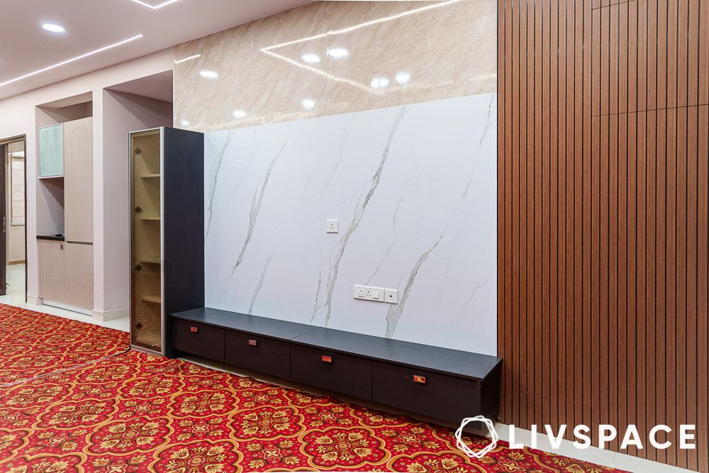 Living room design with marble TV back panel and fluted wall panelling