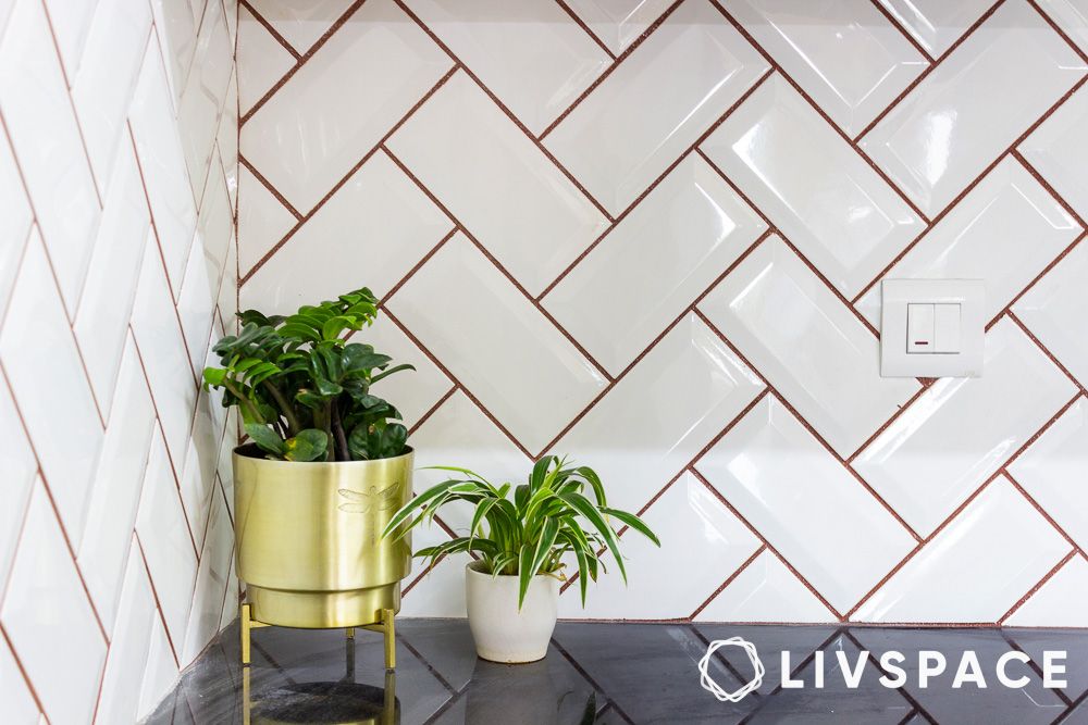 white vitrified tiles in chevron pattern