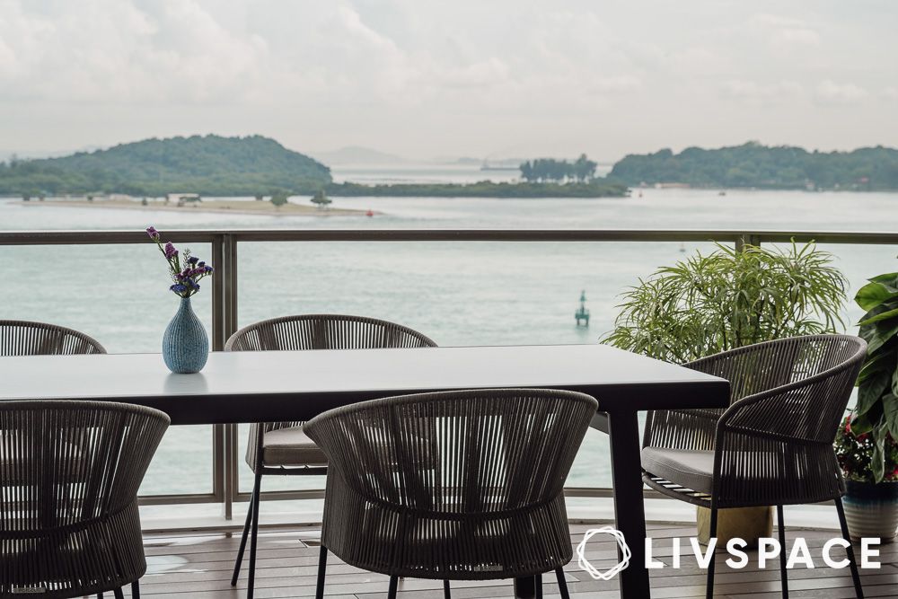 furniture in a patio overlooking the ocean