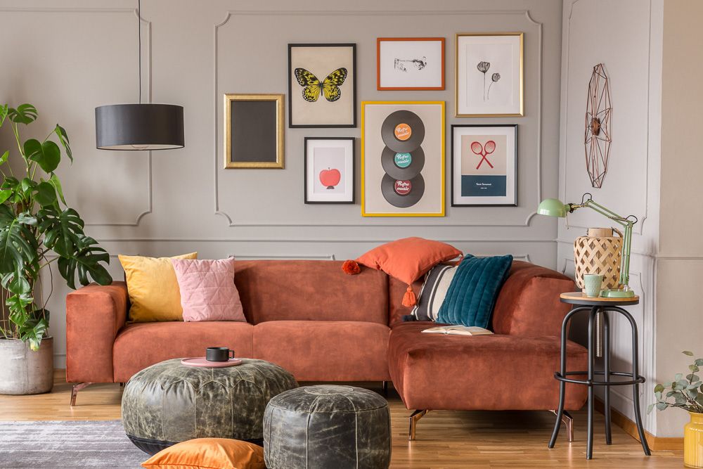 a bohemian living room with photos and art wall