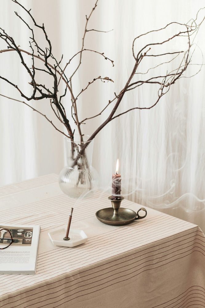incense sticks and twig decor on a table