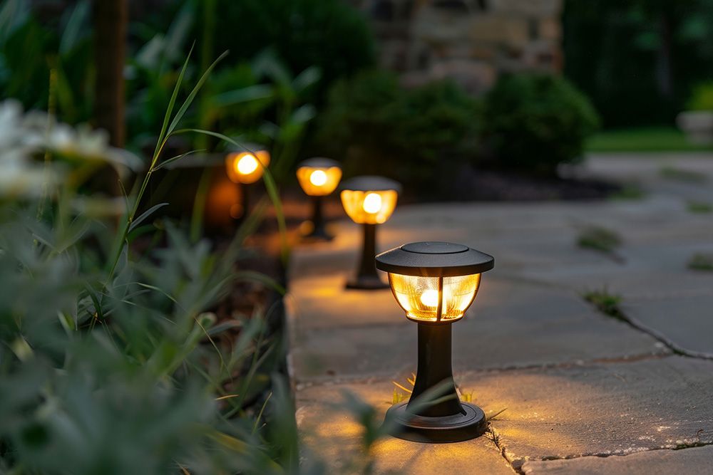 elegant solar garden lights that are also waterproof outdoor lights and bollard lights for outdoor in gold bronze teal and orange illuminate charming scene on dark sidewalk