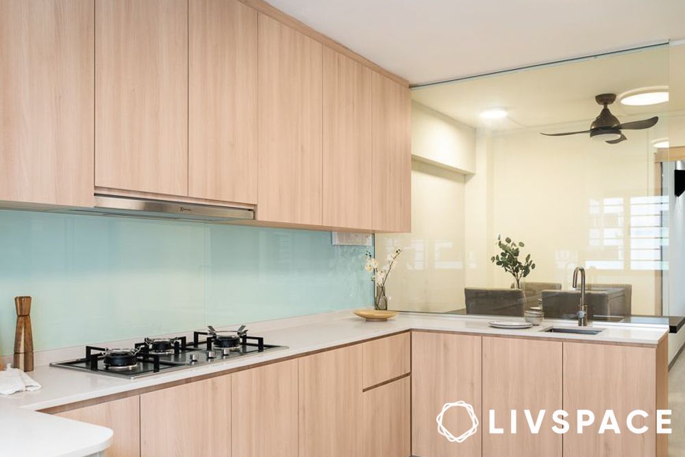 L shape modular kitchen design with a glass partition