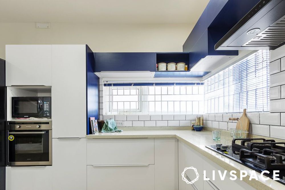 Blue and white L shape modular kitchen design with appliances