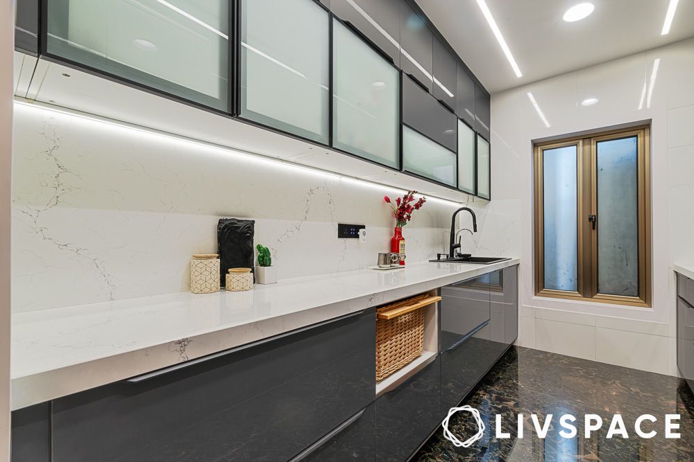Frosted glass upper cabinets and wicker basket storage in a parallel kitchen design