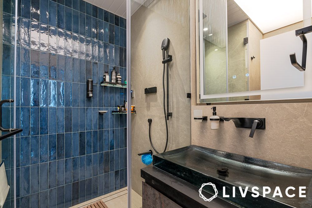 Blue subway tiles in the shower area of a modern bathroom