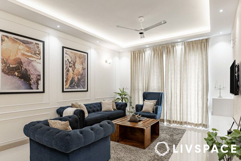 glam living room with blue sofas artwork wall trims