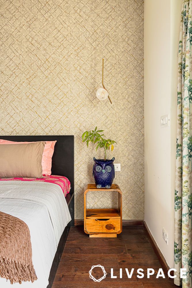 bedside table and wallpaper in bedroom