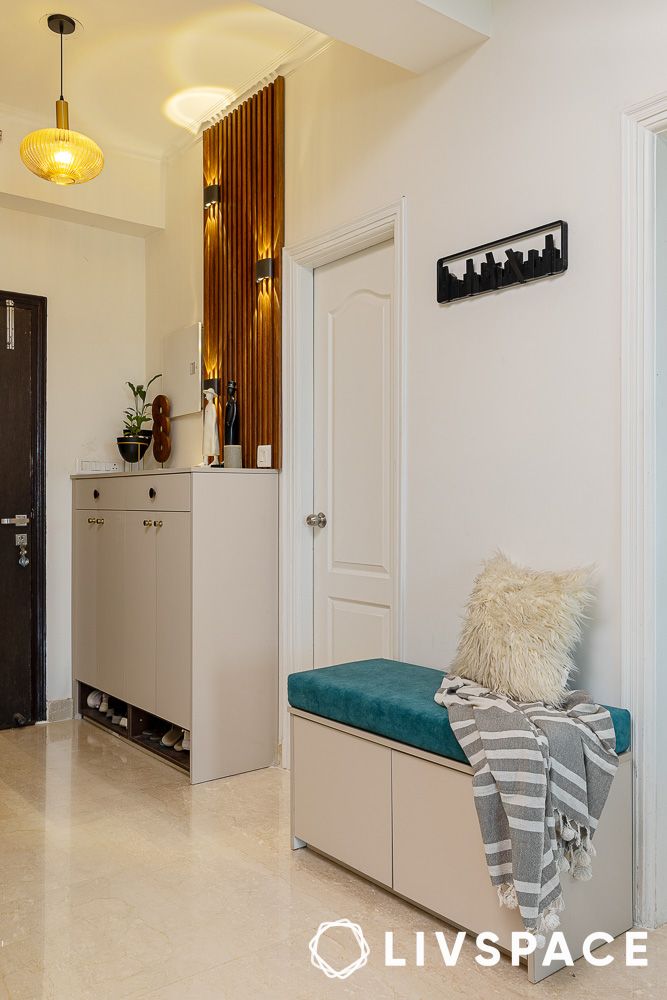 foyer with wooden panels and shoe cabinet