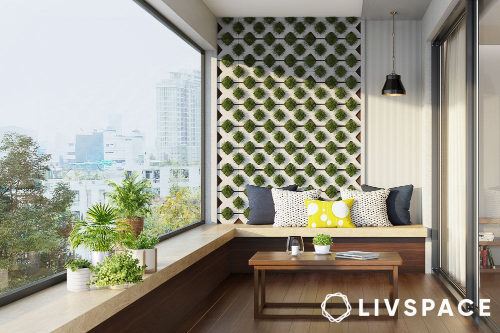 a closed off balcony area with window wall and seating