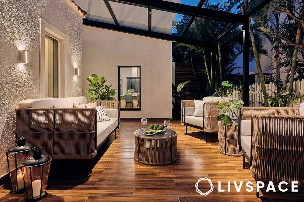 a cosy patio with cane furniture and plants