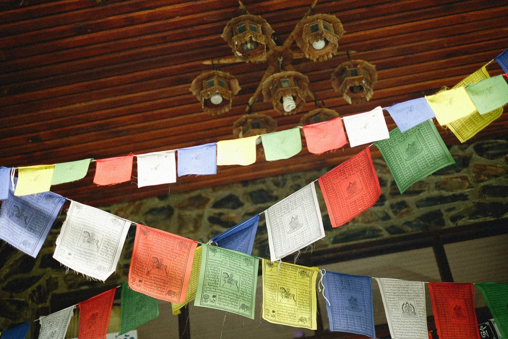 colourful tibetan flags hung inside a home