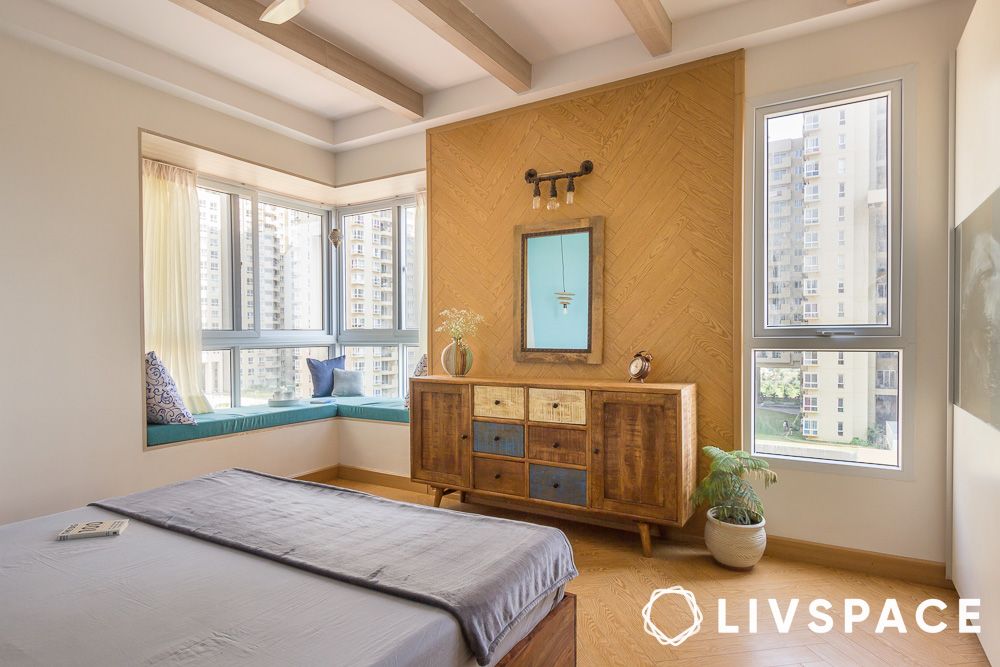 bedroom with window seat and wooden furniture