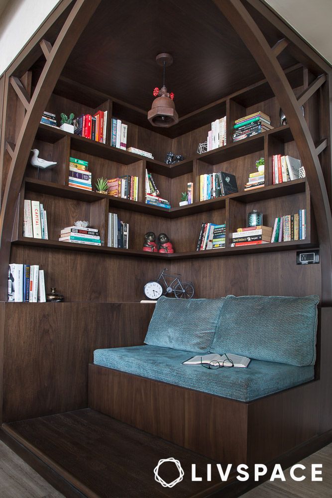a library corner with wooden floating shelves