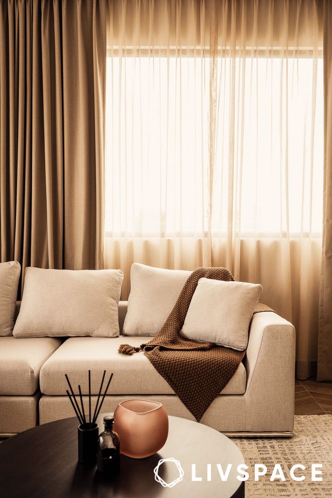 living room with sofa and sheer curtains