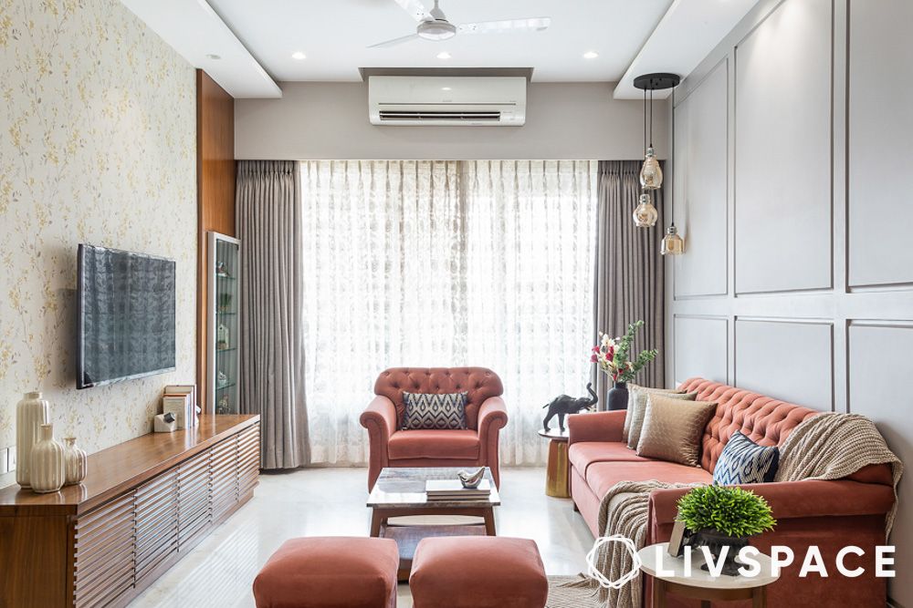 a living room with sofa armchair and ottomans