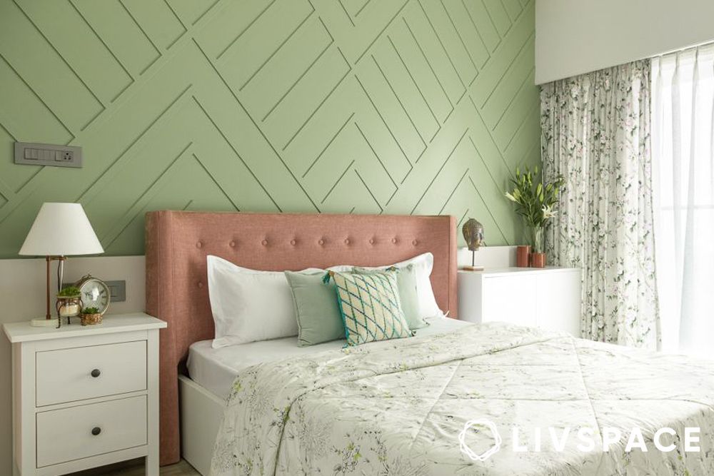 green bedrooms with wall trim detailing and white bedding