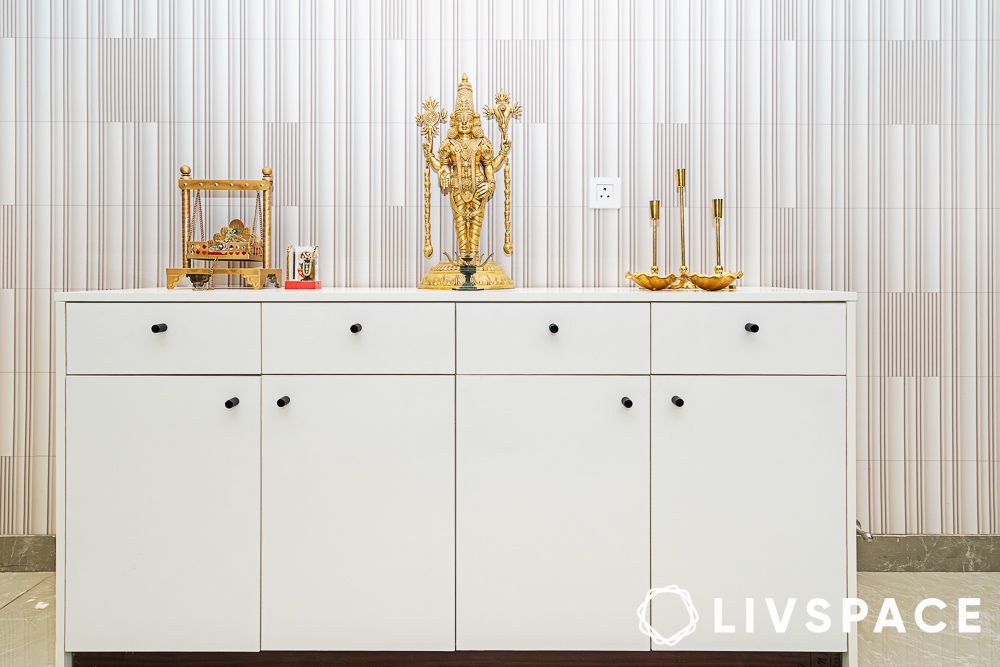 while console table with golden decor in foyer