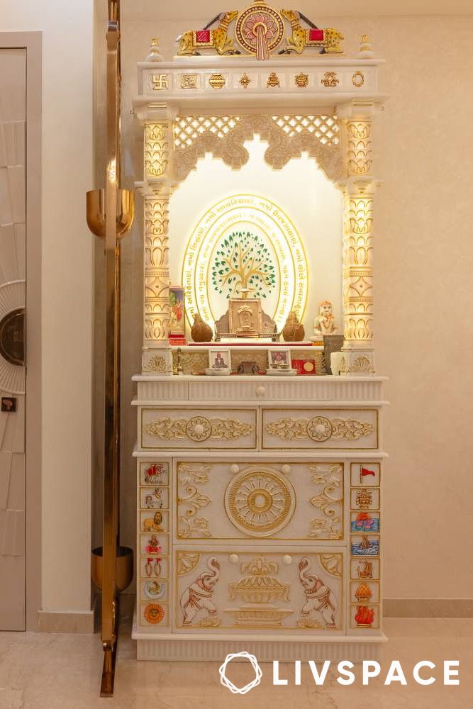 ornate pooja room design with pillars and colourful motifs