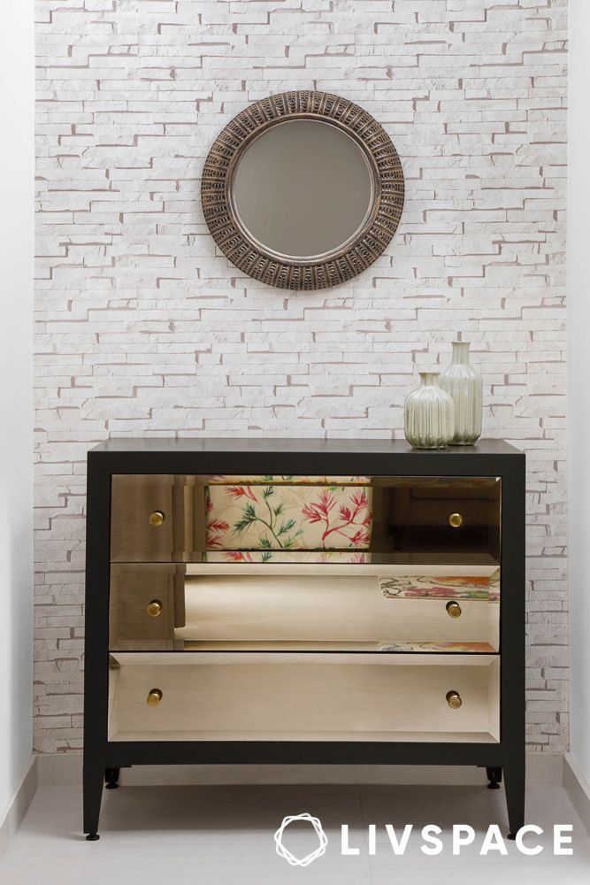 Console tables with decorative mirror above