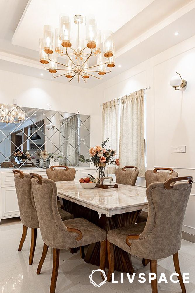 white dining hall with chandelier