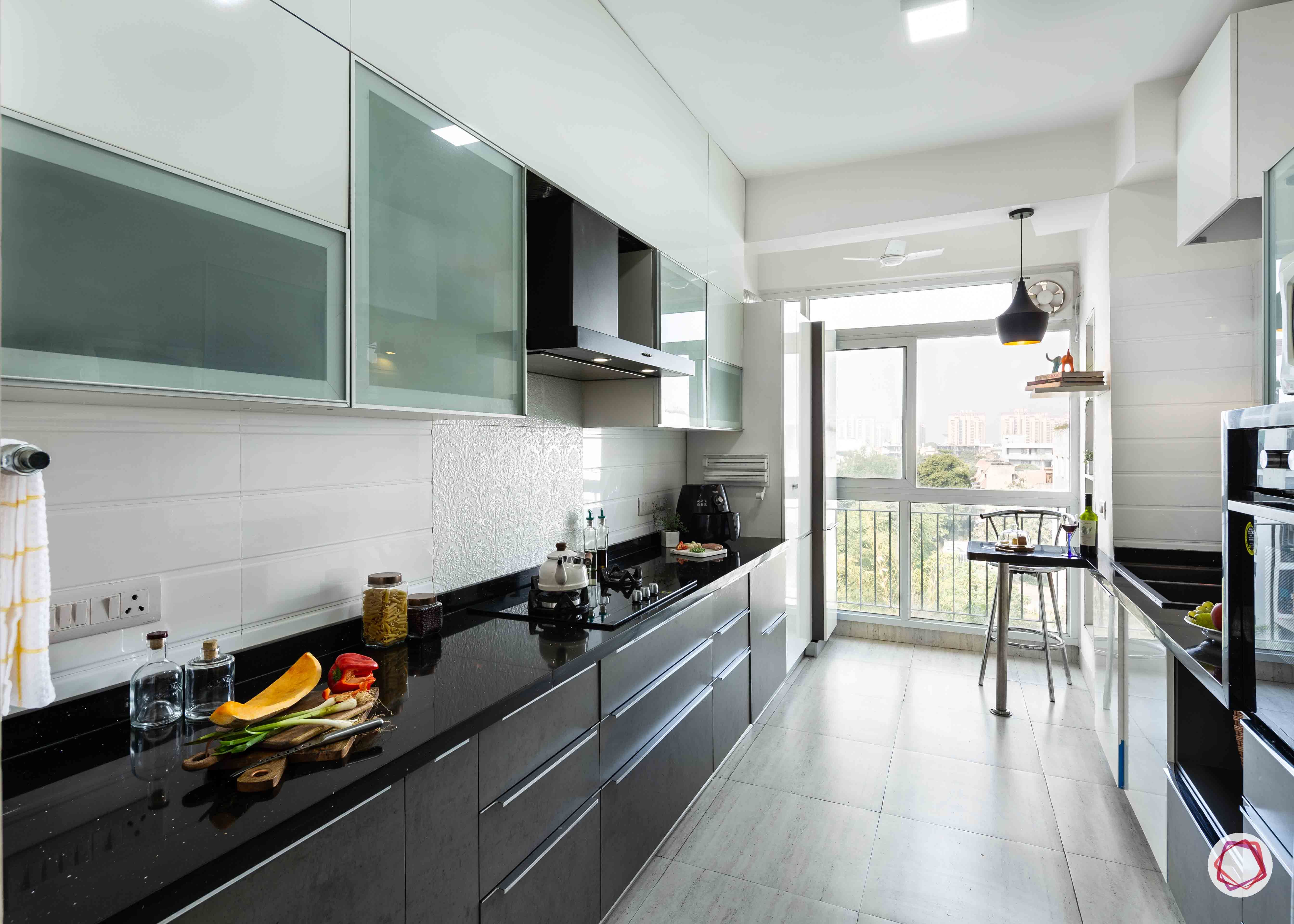 small kitchen design-grey-white-cabinets-breakfast-table-black-counter