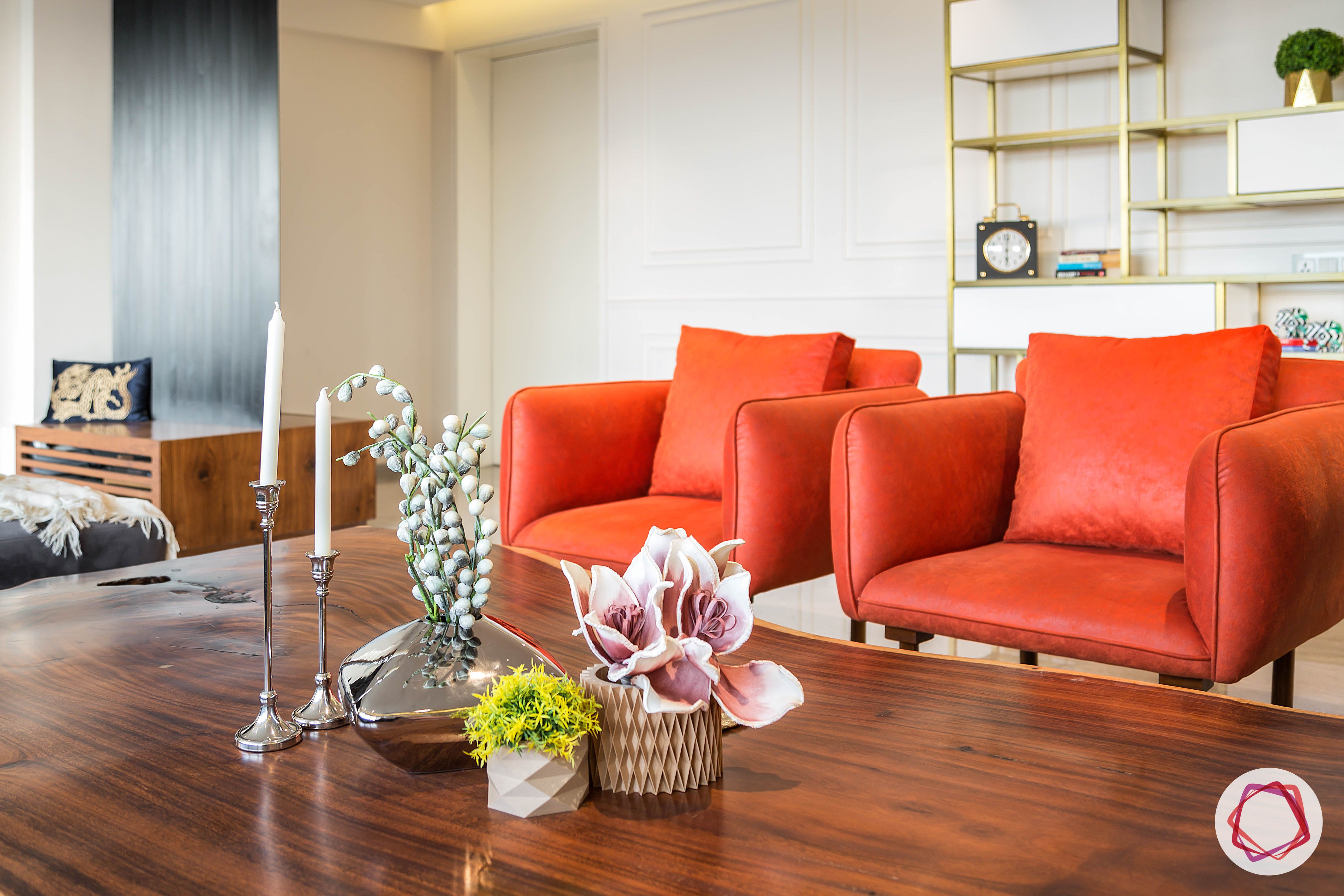 condo-interior-design-orange-armchairs-wooden-coffee-table