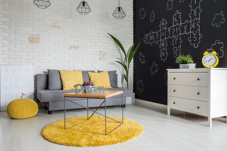 yellow rug-yellow poufs-white brickwall-grey sofa designs
