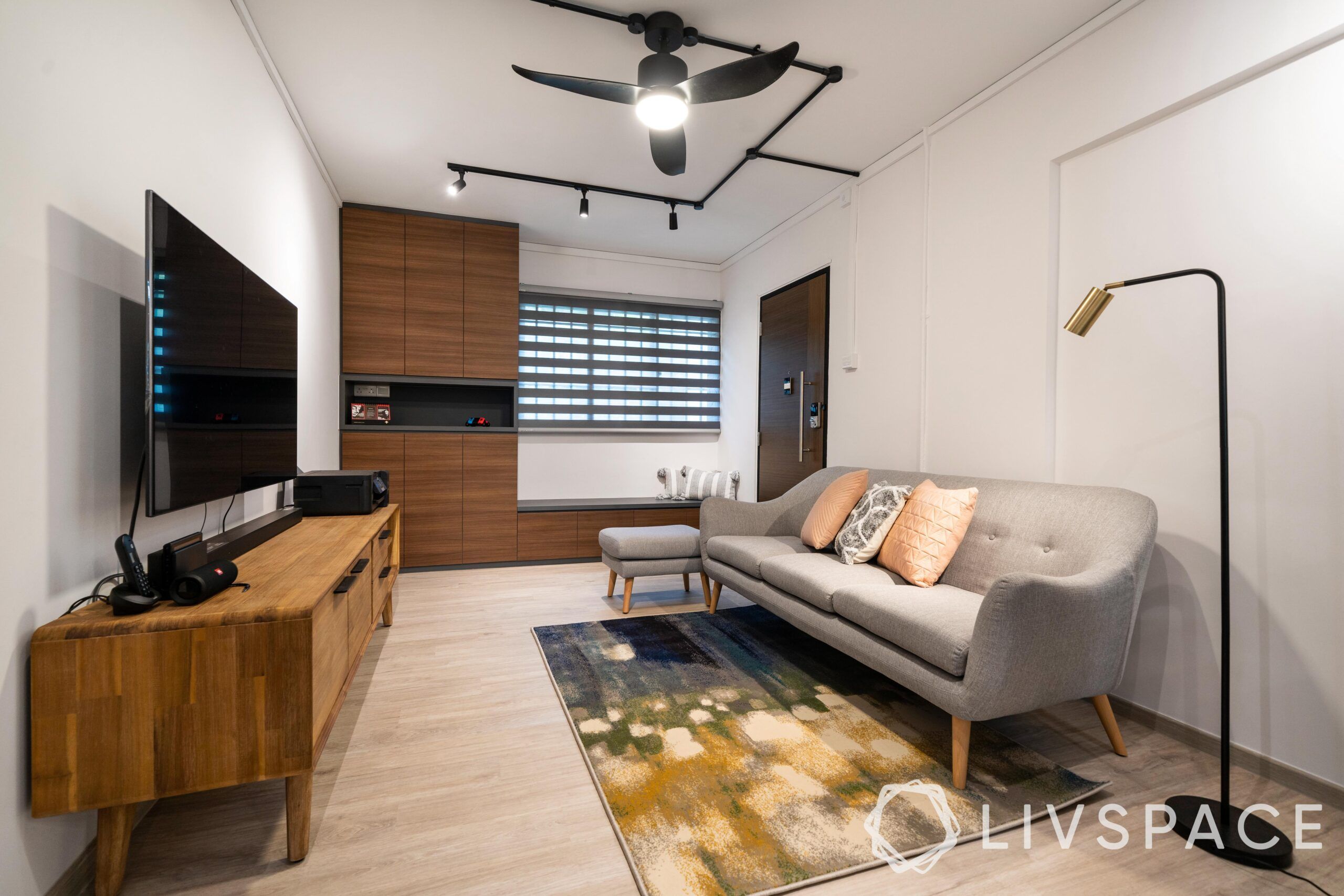 hdb interior design singapore-grey sofa-wooden cabinet-seating-blinds-wooden tv unit