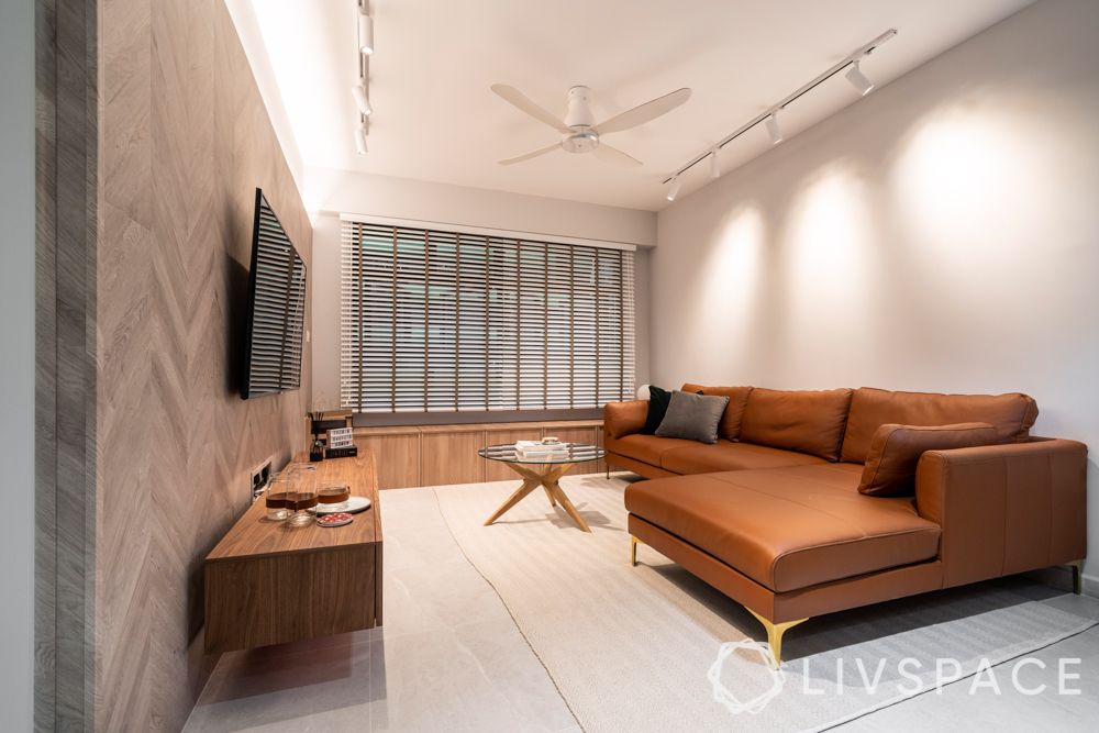 home-renovation-brown-sofa-wooden unit-grey-wall-windows