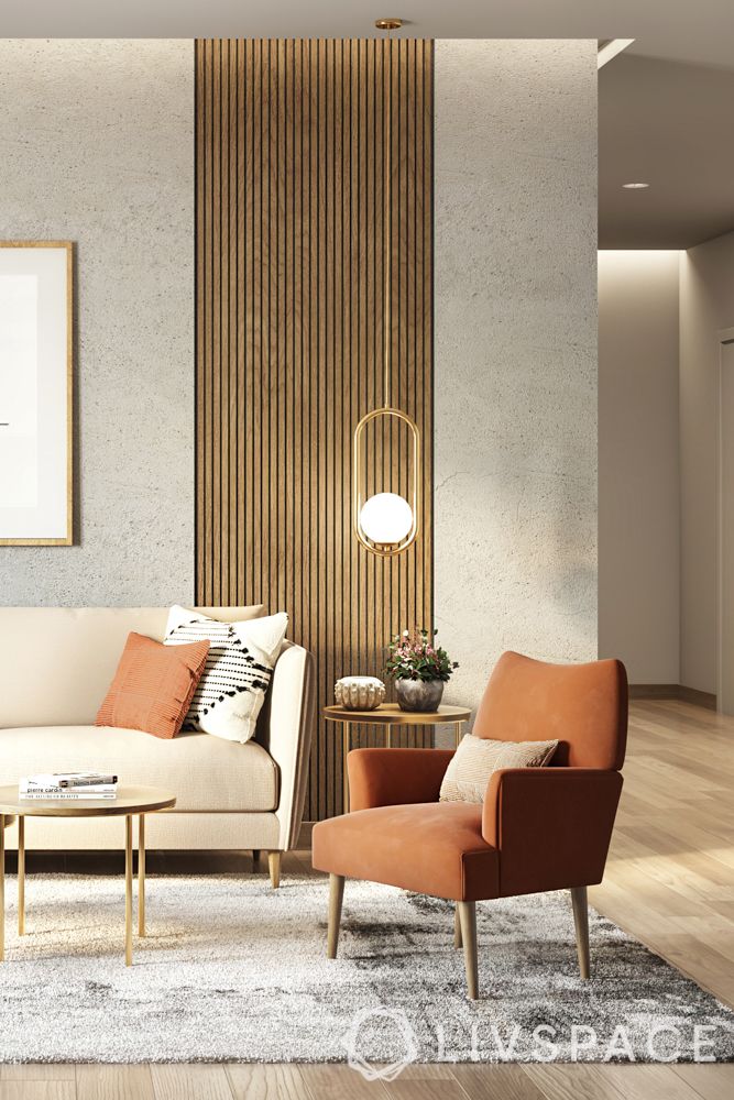 room decoration-fixtures-orange armchair-lighting-artwork-wall treatments