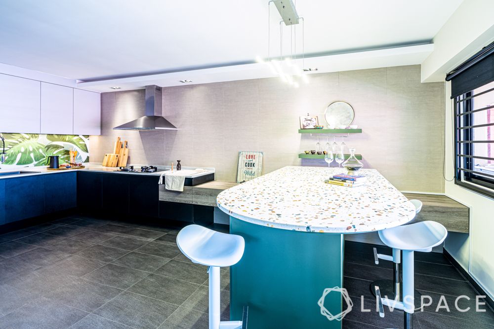 kitchen-blue bar unit-terrazzo countertop-L-shaped kitchen-open layout-leaf backsplash