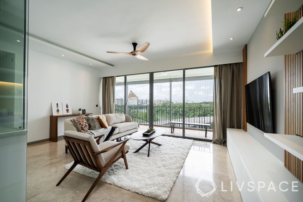condo design-sofa-armchair-coffee table-rug-feature wall-balcony