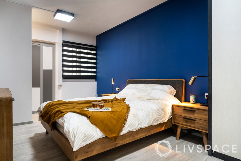 room colour ideas-wooden bed and bedside tables-blue accent wall