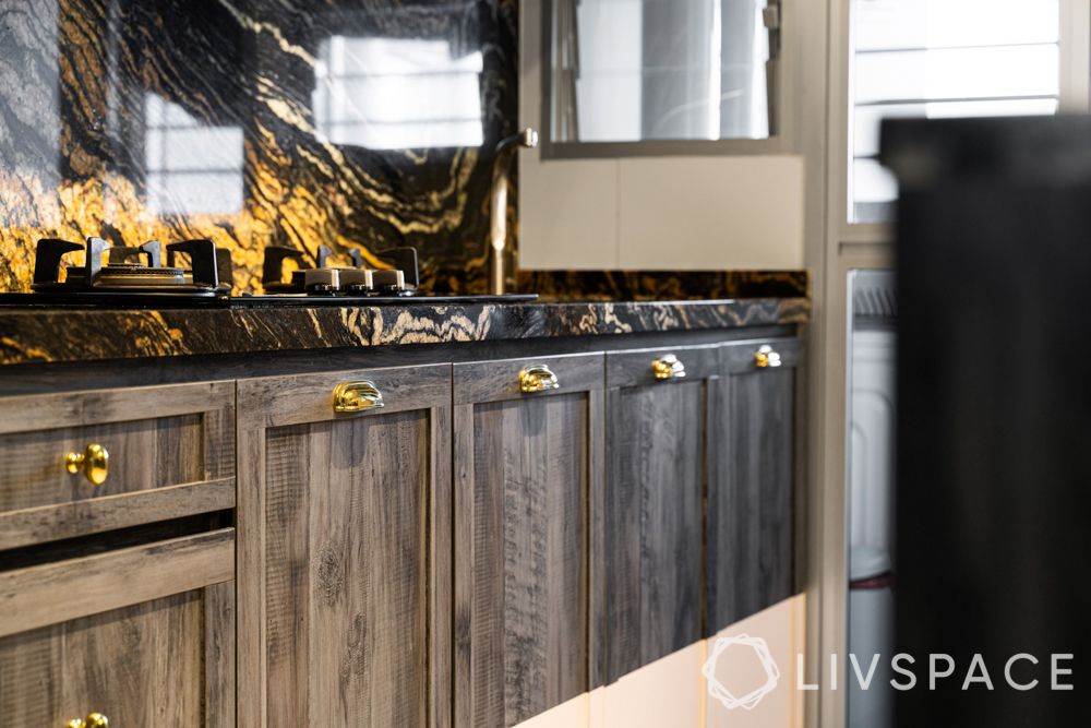 granite-black and gold-storage cabinets-gold knobs