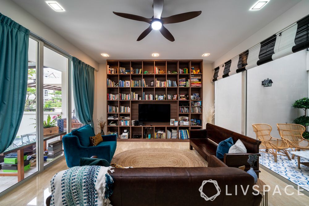 tv-wall-design-wooden-book-shelves-brown-blue-sofa